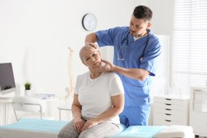 steopath assessing a patient's neck and shoulder at Tim Wood Healthcare clinic in Maidstone