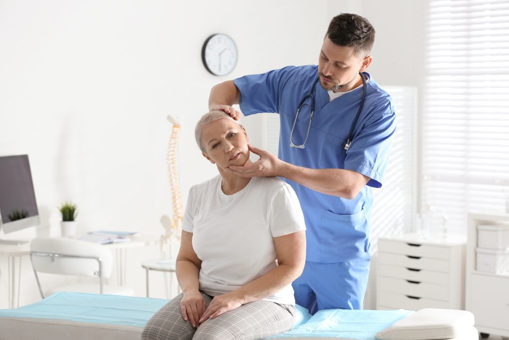 steopath assessing a patient's neck and shoulder at Tim Wood Healthcare clinic in Maidstone
