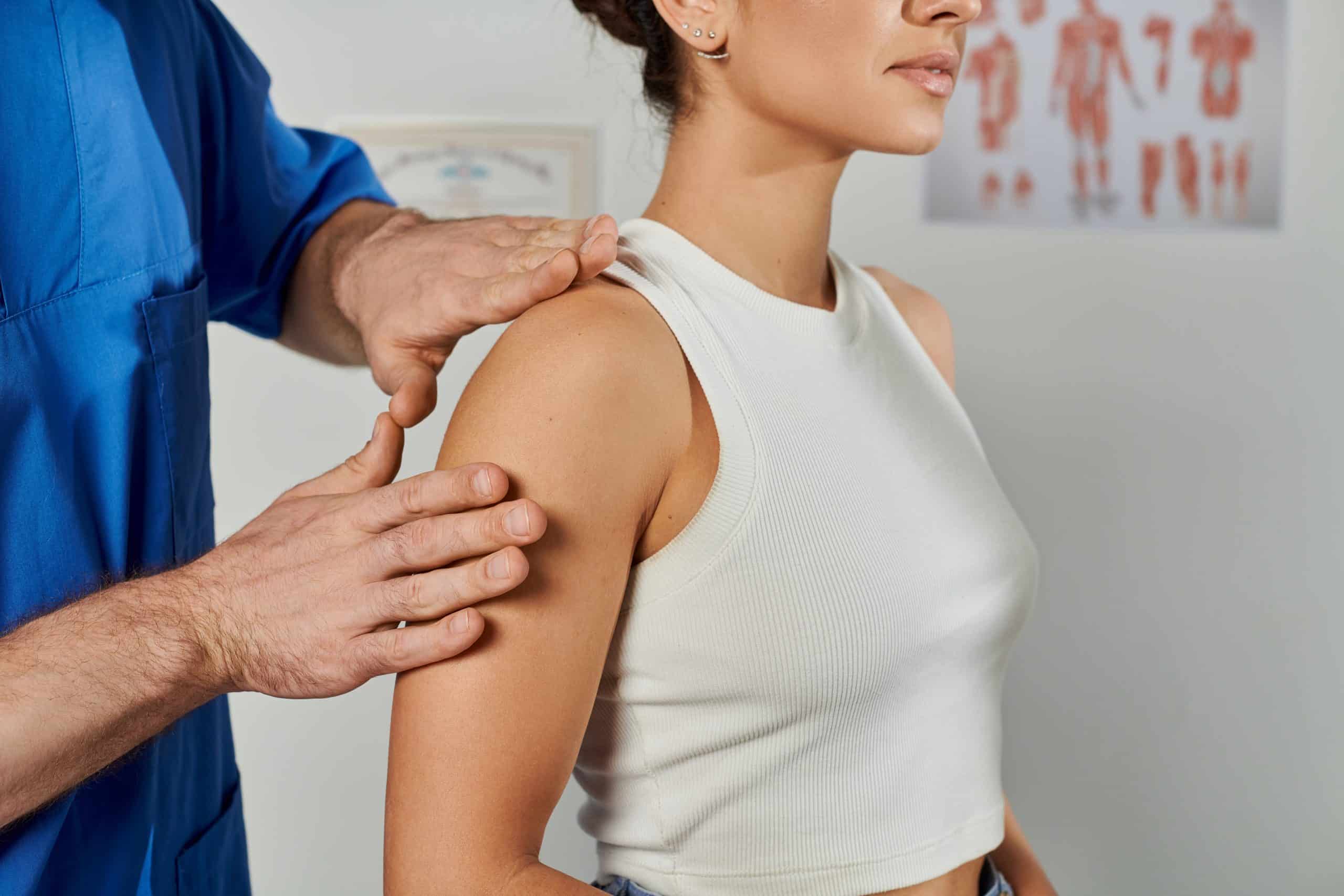 Osteopath assessing a patient's shoulder at Tim Wood Healthcare clinic in Rainham, Kent