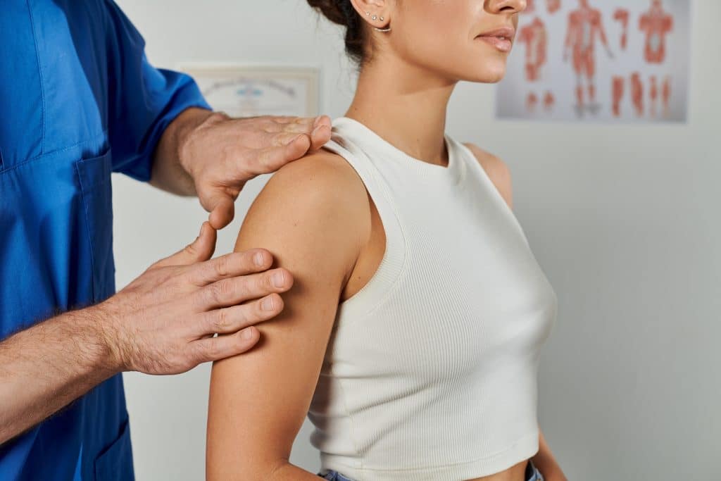 Osteopath assessing a patient's shoulder at Tim Wood Healthcare clinic in Rainham, Kent