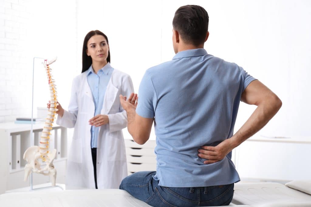 Osteopath assessing a patient with sciatica at Tim Wood Healthcare Rainham clinic