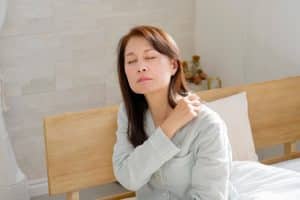 Osteopath gently assessing a patient's frozen shoulder at Tim Wood Healthcare clinic in Maidstone