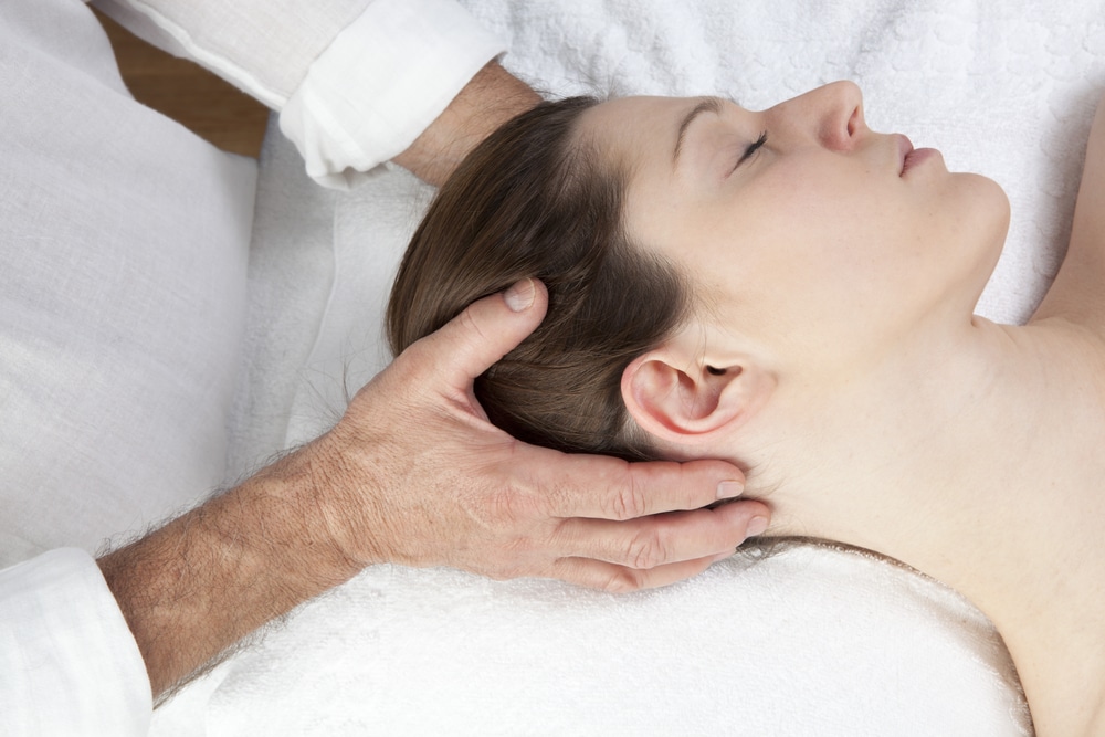 Osteopath treating a migraine patient